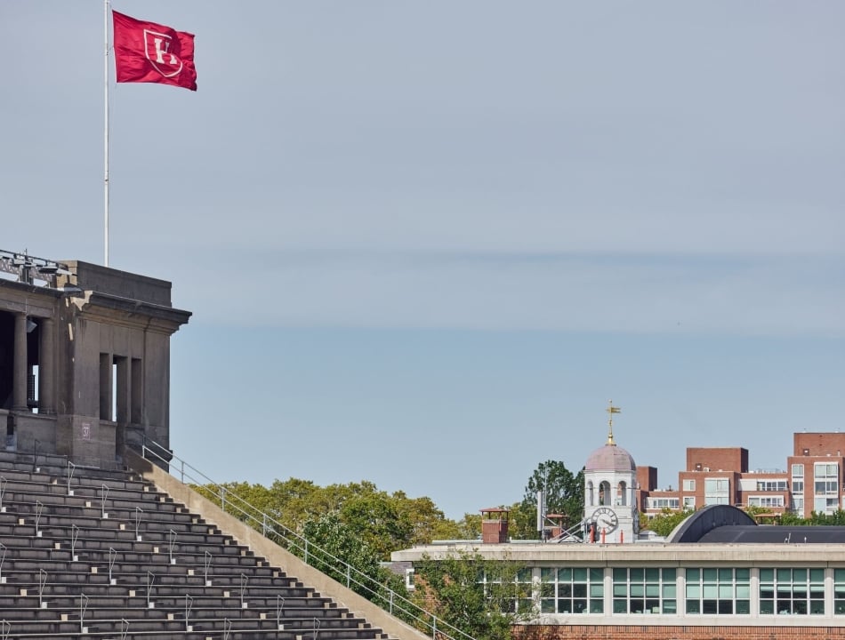 Harvard Stadium with the flag raised, flapping in the wind