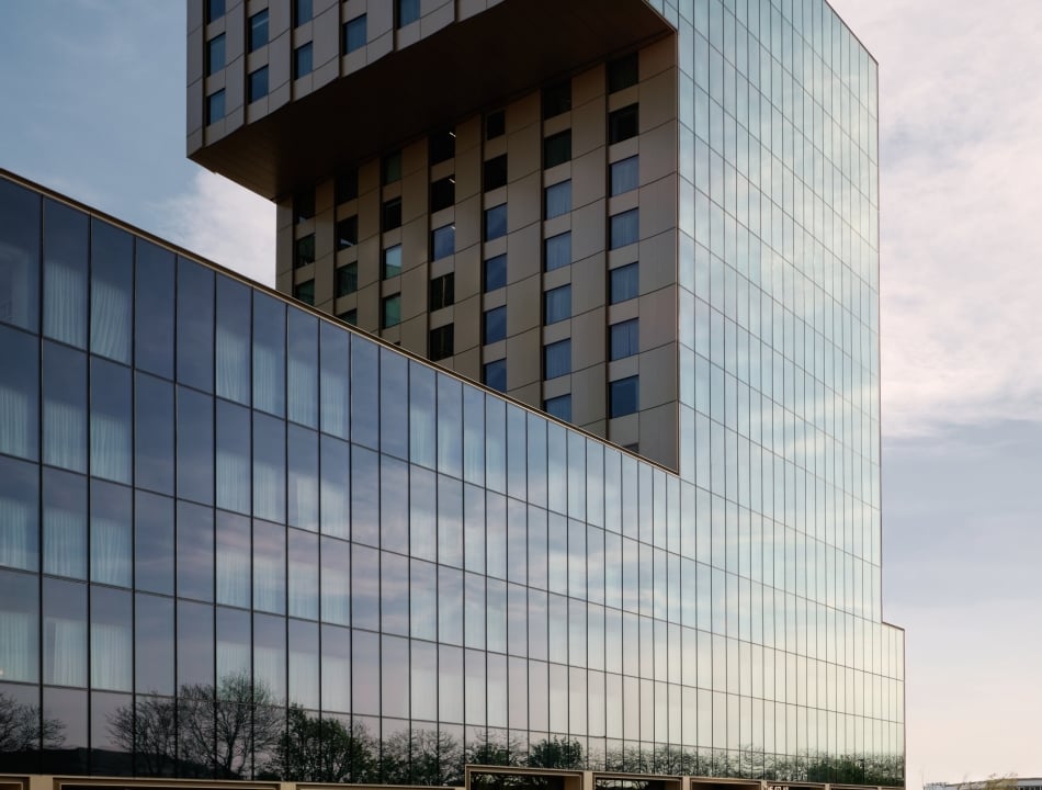View of The Atlas hotels glass facade at street level