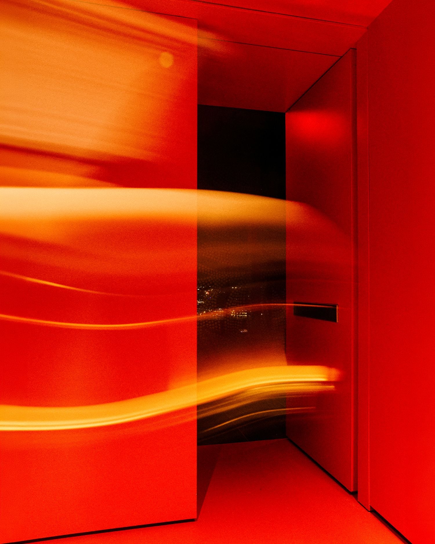Red-lit abstract interior with curved light streaks across glossy panels and walls in a cornered hallway.
