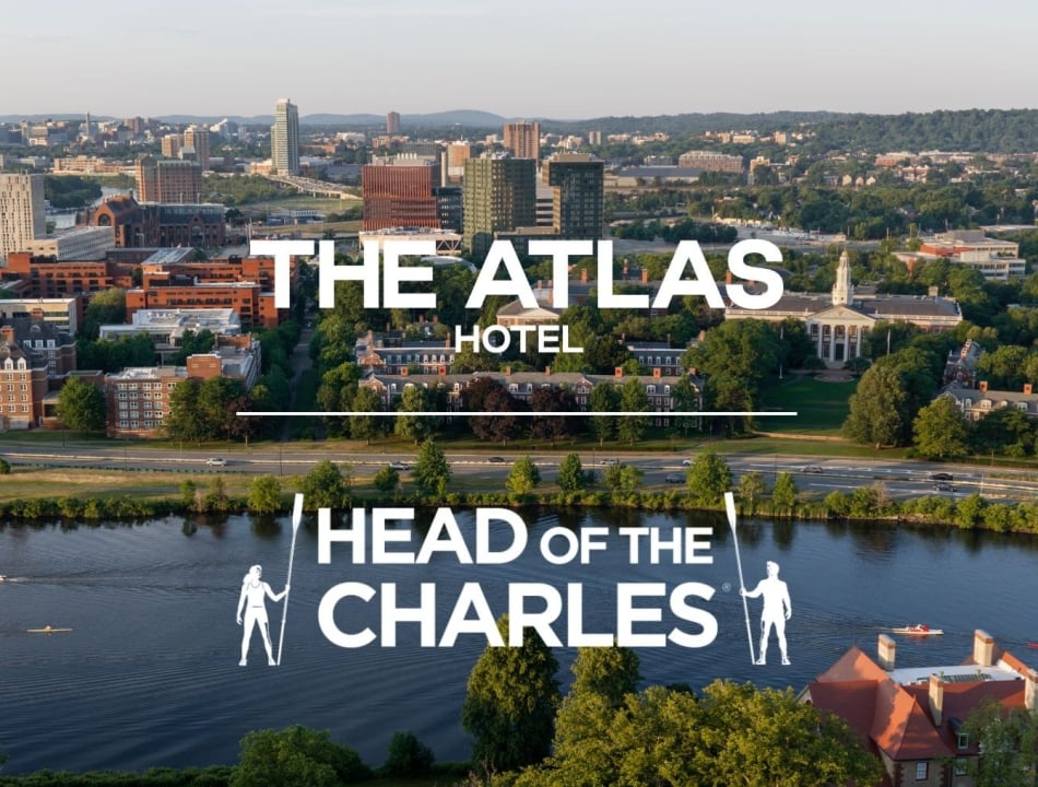 Aerial city view with large white text reading 'The Atlas Hotel' and 'Head of the Charles' logo over the riverfront.